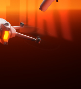 Close-up detail shot showing orange/red fabric or material with warm lighting against dark background.