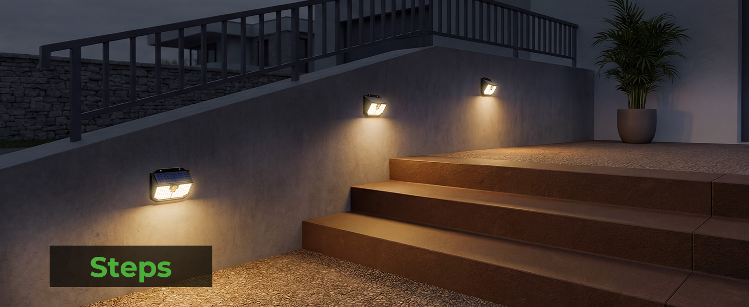 Text reads 'Steps'. Outdoor concrete steps illuminated by warm wall-mounted lighting in evening/night setting, with natural stone or concrete walls visible.