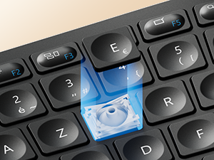 Close-up of a black computer keyboard with a blue illuminated key featuring a printer icon, indicating a dedicated printing function on the keyboard.
