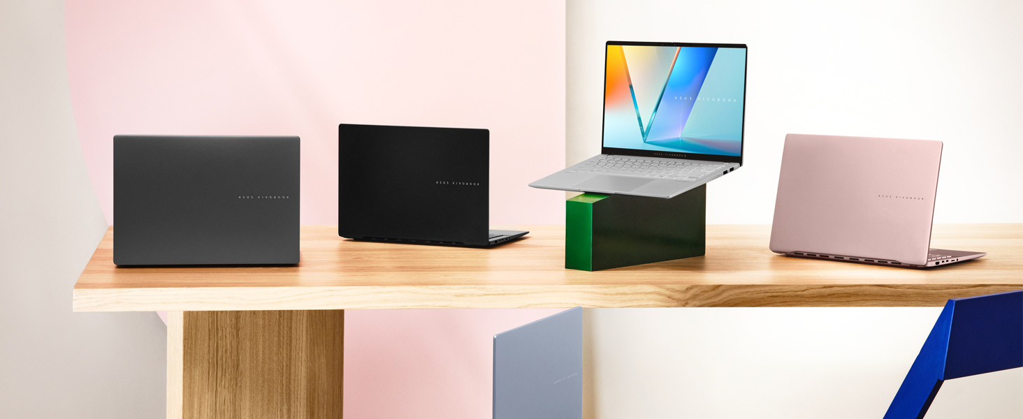 Multiple product shots showing tech devices on wooden surfaces against light backgrounds, featuring laptops and tablets in various angles and configurations.