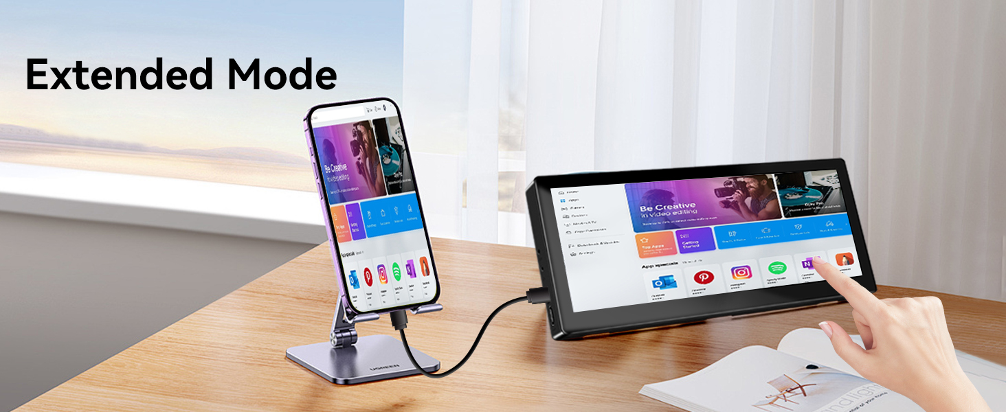 Text reads 'Extended Mode'. Smartphone in stand displaying colorful interface beside tablet device on wooden desk surface.