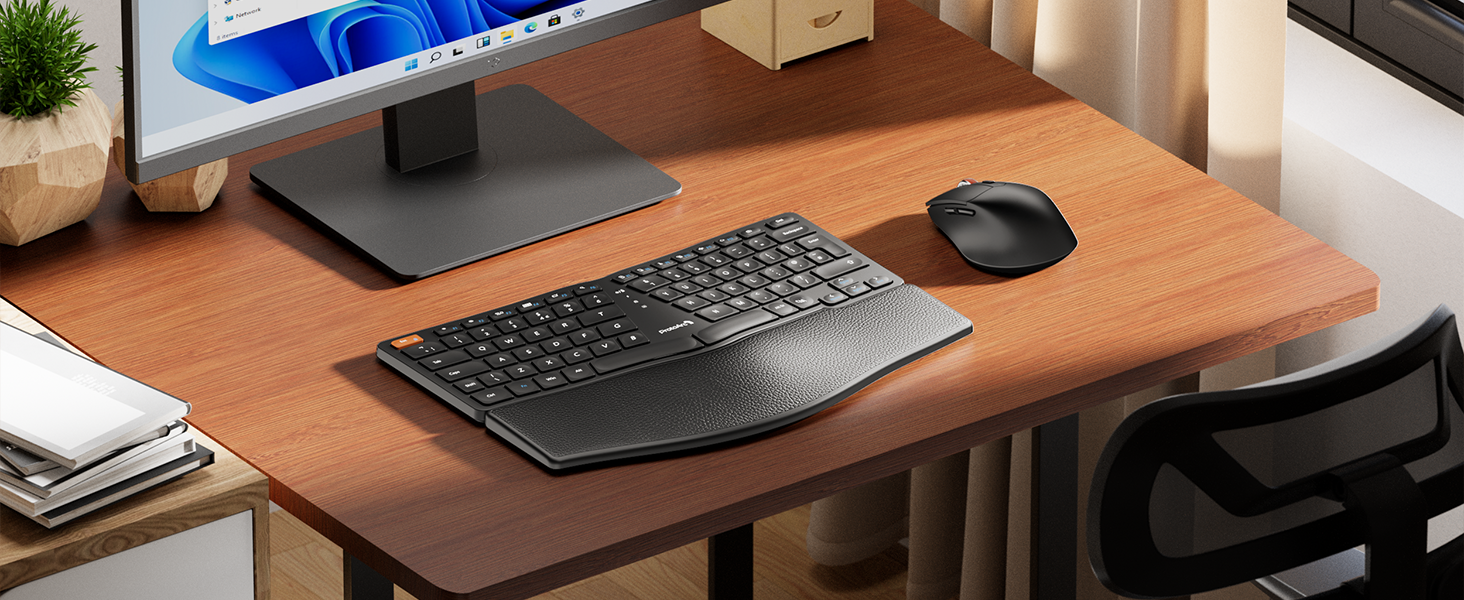 Ergonomic computer setup on wooden desk featuring a curved keyboard, wireless mouse, and monitor stand. Office supplies and plant visible in background.
