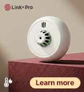 Text reads 'Smart Temp'. White circular device with digital display, appears to be a temperature monitoring or control unit.