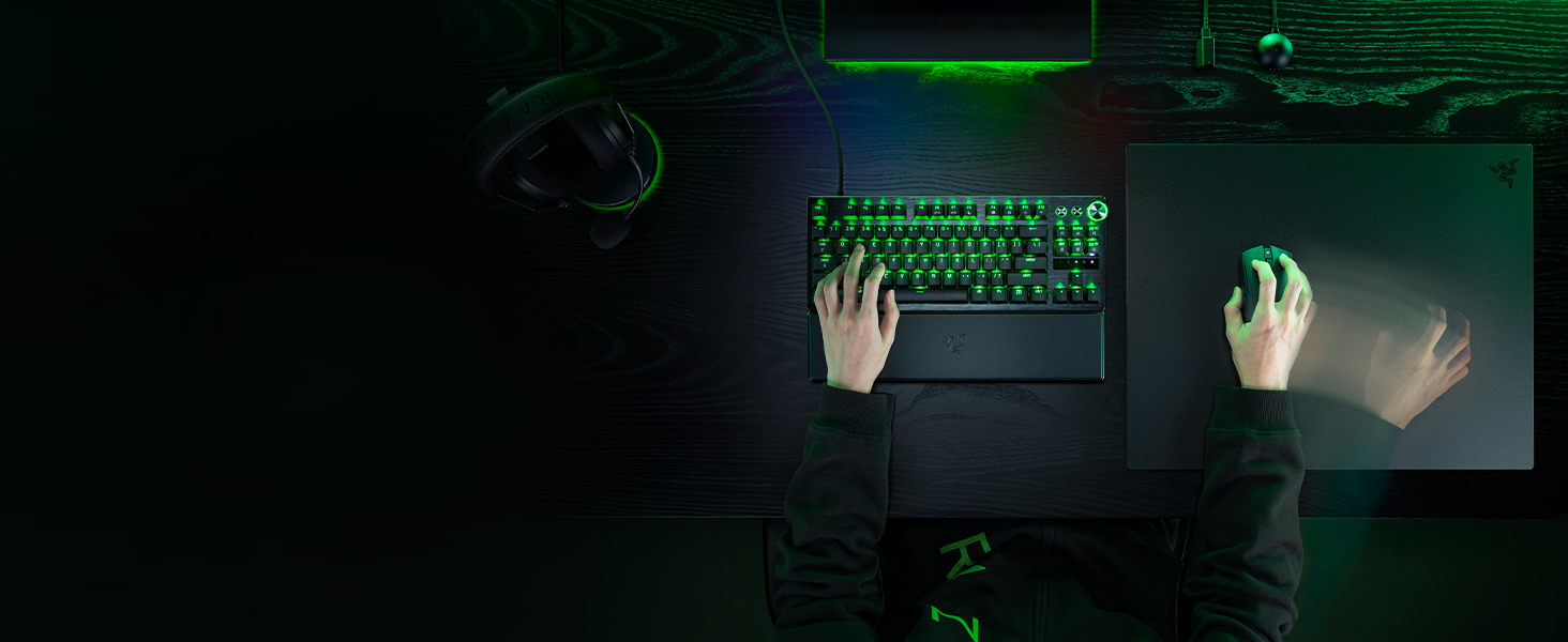 Dark indoor scene showing illuminated text and glowing hand silhouettes against green-lit background. Text partially visible but unclear in image.