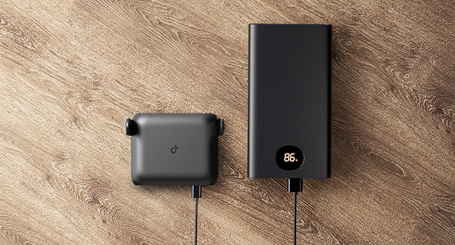 Multiple shots of black charging adapters and cables on a wooden surface, showing various angles of USB power charging devices.