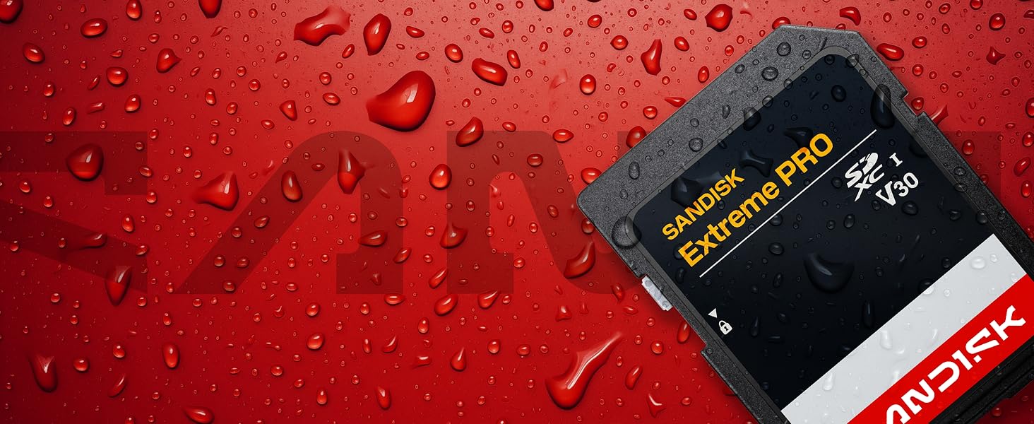 Close-up of water droplets on red surface with black credit or membership card visible.