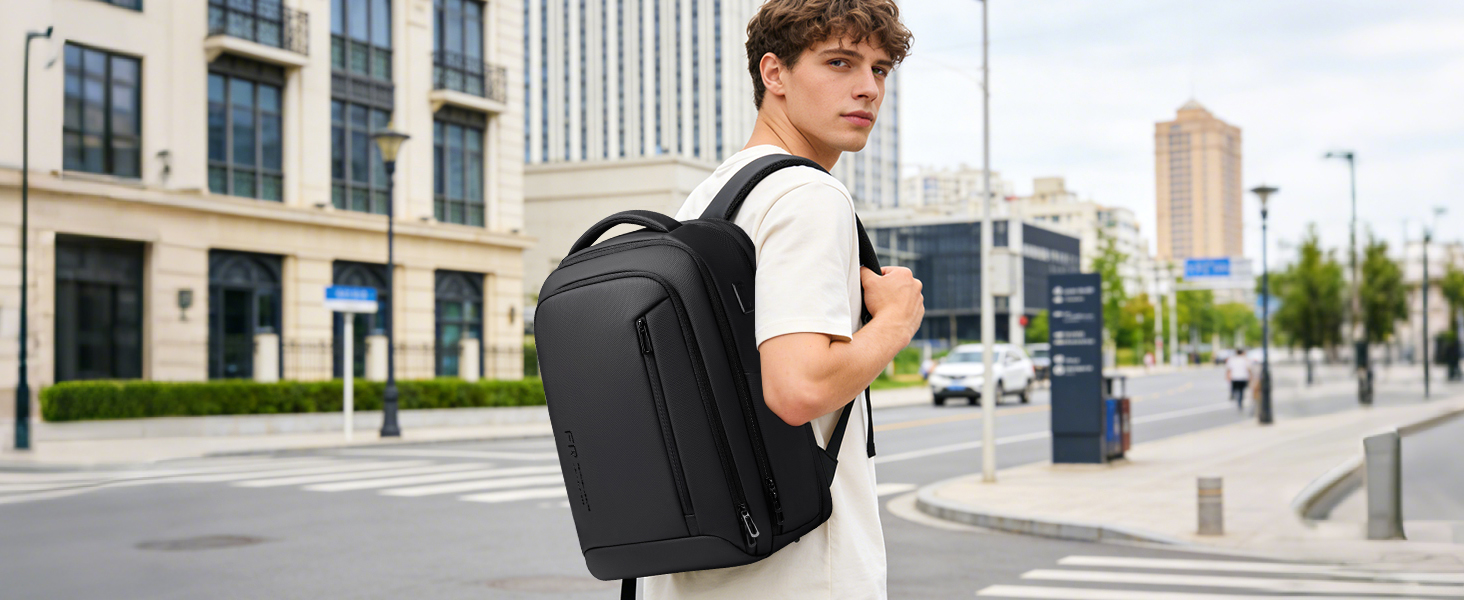 Multiple views of a black backpack in urban settings, showing person wearing it while walking and standing in front of modern buildings and streets.