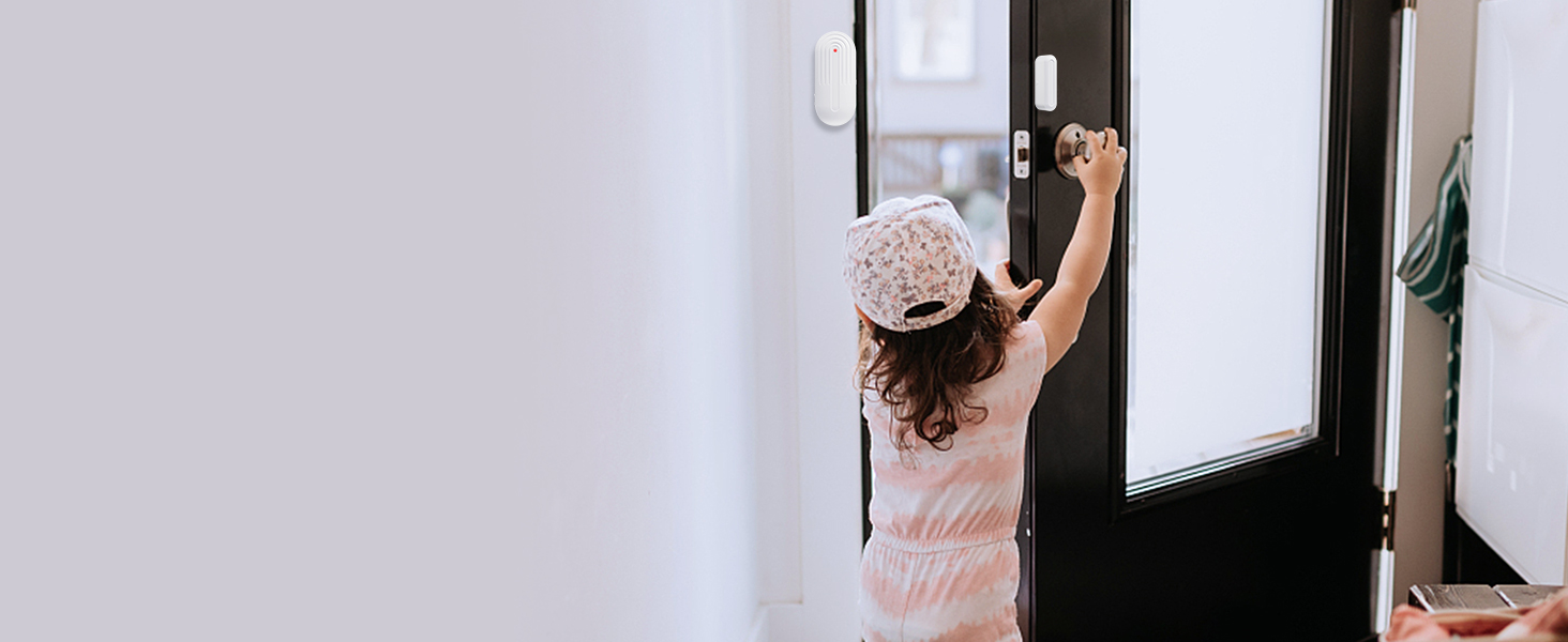 Small child in pink shirt and knit hat, reaching up to open or close white window blinds.