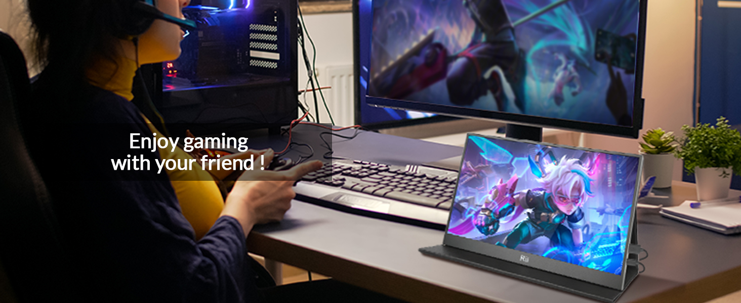 Text reads 'Enjoy gaming with your friend!' Portable gaming display showing vibrant game graphics alongside desktop setup in dimly lit environment.