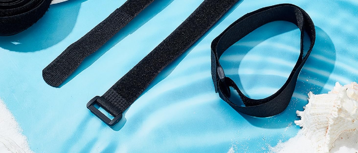 Black hook-and-loop straps and fasteners displayed on light blue background with decorative flowers and starfish accents.