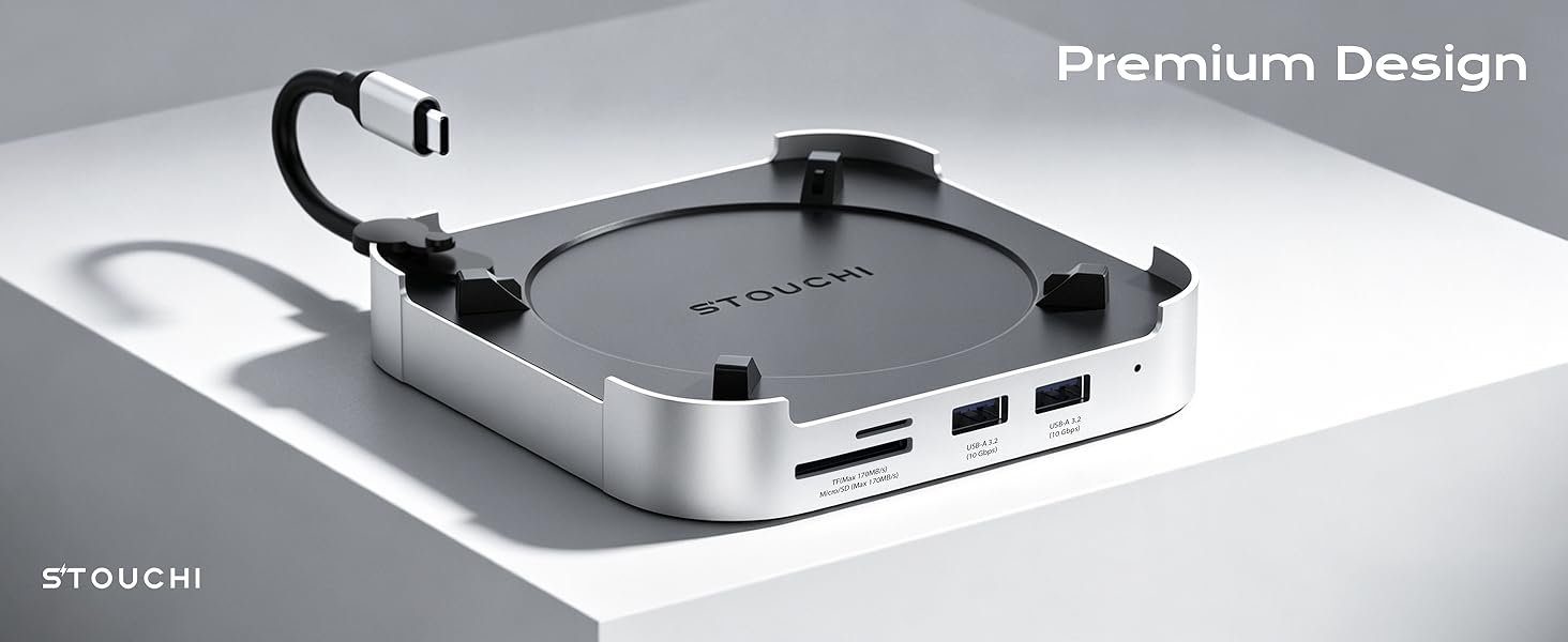 Text reads 'Premium Design' and brand mark 'TEGUCHI'. Gray and white portable USB hub or docking station with multiple ports and cable attachment, displayed on white surface.