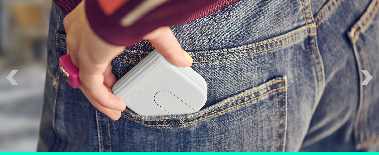 Person in denim jeans inserting white oval-shaped handheld device into back jean pocket, demonstrating portability and compact size of product.
