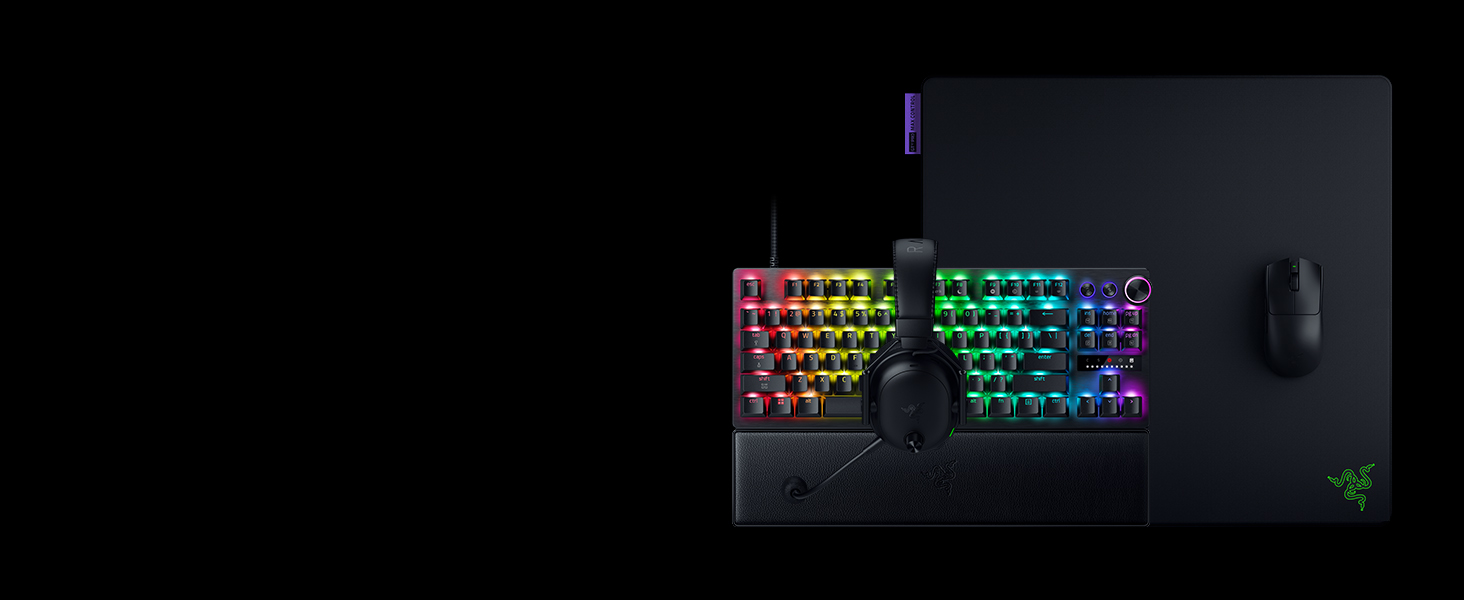 RGB gaming keyboard with illuminated keys displaying rainbow colors against black background. Shows mechanical keyboard with customizable lighting effects.