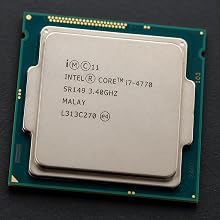 Text reads 'i400©11 INTEL® CORE™ i7 3770 SR1A9 3.40GHZ MALAY L313C270 ©'. Intel Core i7 3770 processor on green circuit board with integrated heat spreader.