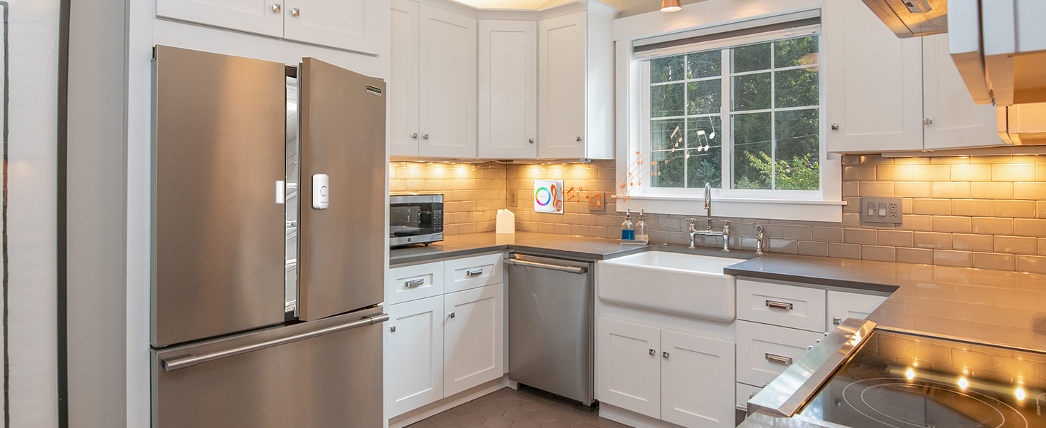 Modern kitchen interior views showing white cabinets, stainless steel appliances, and natural lighting from windows.
