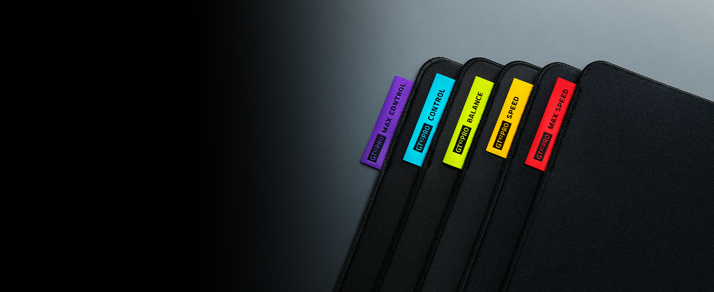 Five USB flash drives arranged in a row, each with a different colored tab: purple, blue, yellow, orange, and red against a black background.