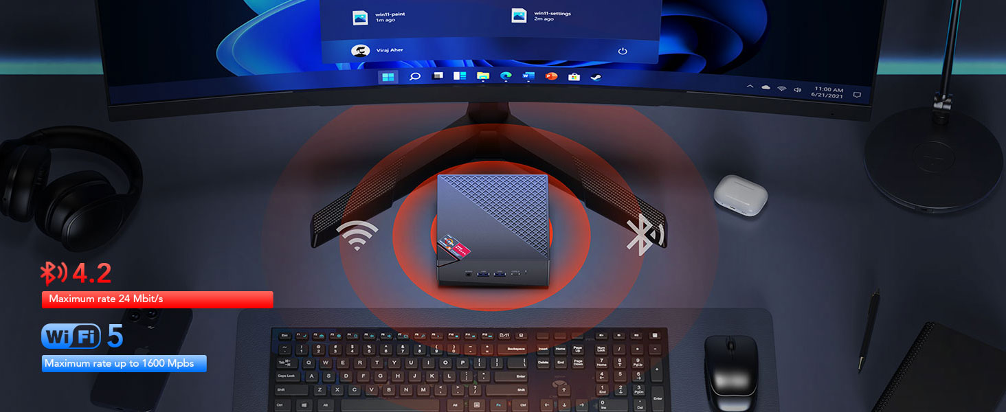 Computer gaming setup with curved monitor displaying game interface. Keyboard, mouse, and speaker visible on desk.