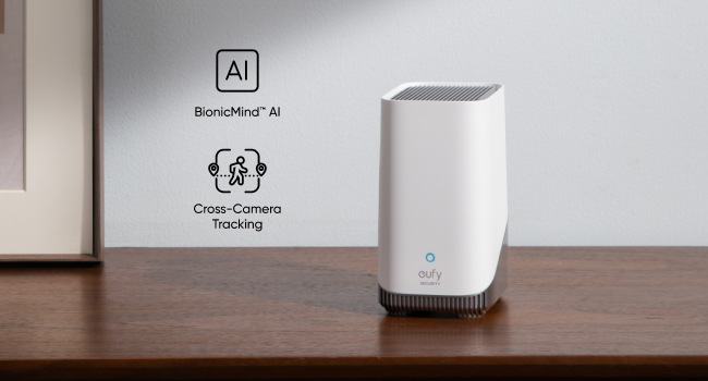 White rectangular device on wooden surface, labeled with AI and cross-camera technology icons, suggesting an AI-powered camera or computing device.